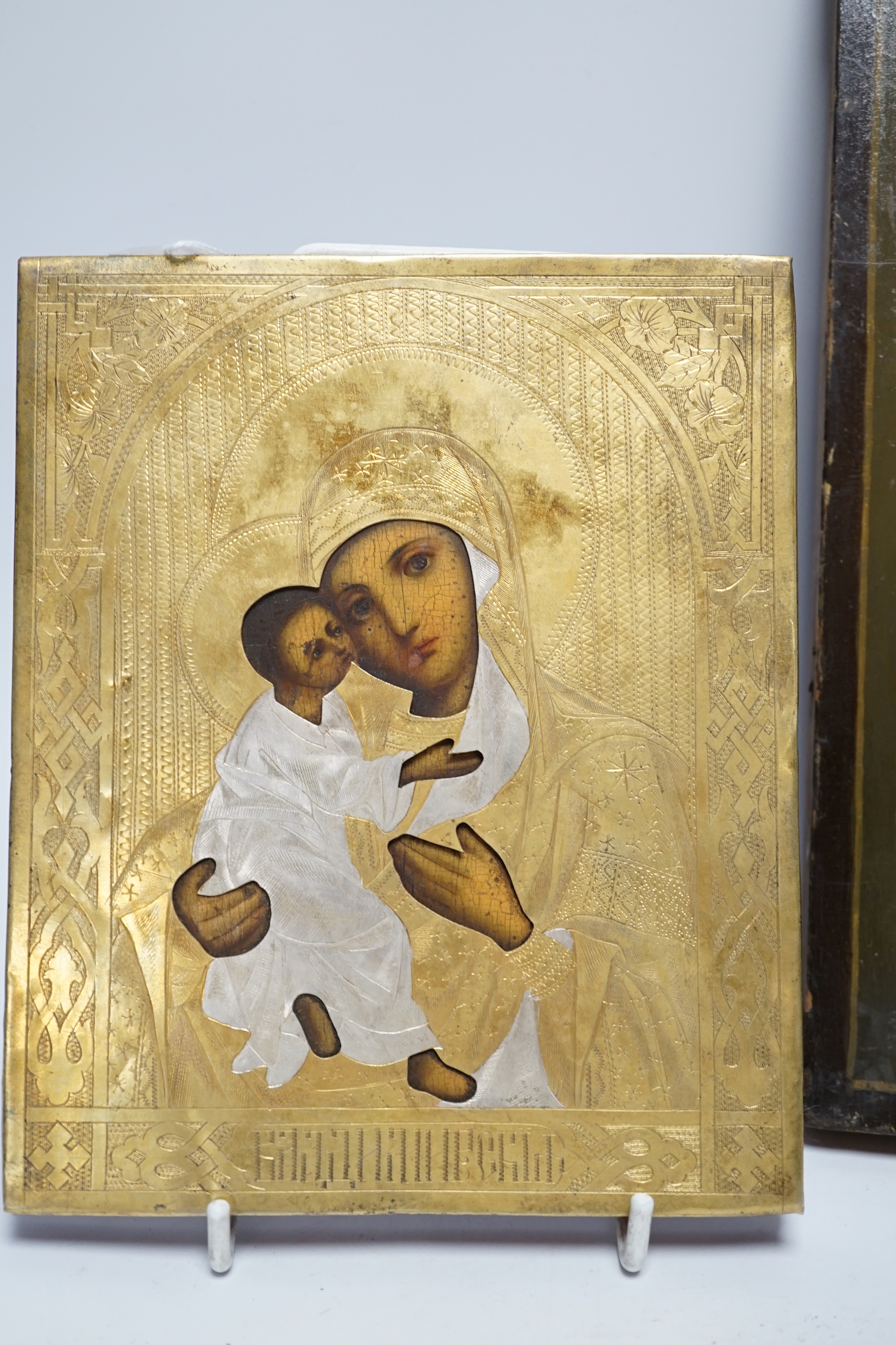 An early 20th century Russian Icon painted on wooden panel of Christ, with inscription and four seals reverse together with a later smaller Icon, largest 22.5cm wide x 27cm high